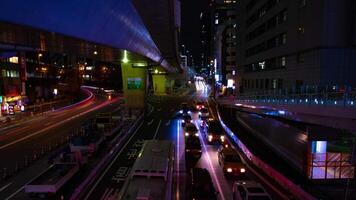 A night timelapse of the neon street at the downtown in Shibuya Tokyo wide shot tilt video