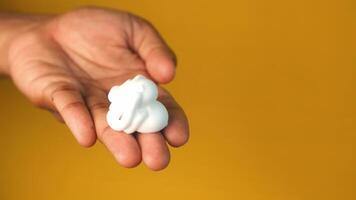 shaving foam on hand on yellow background video