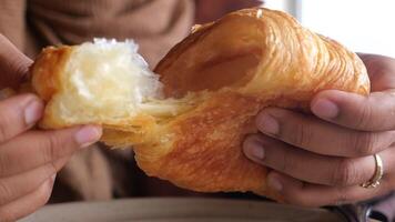 closeup of hand breaking a croissant bun video