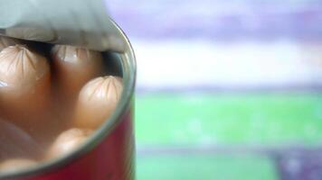 sausage in a tin container on wooden background video