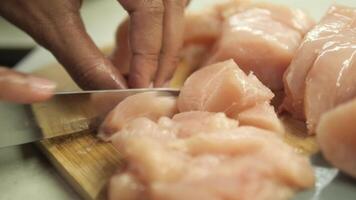 cutting chicken fillet on a chopping board video