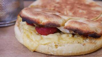 sandwich or toast with sausage served on a plate on tiles background video