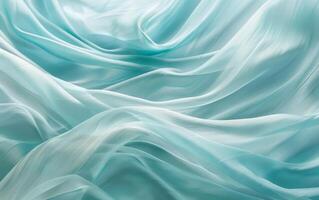 Luxurious teal green satin fabric draped in soft, sinuous waves that accentuate the rich sheen and fluid texture. photo