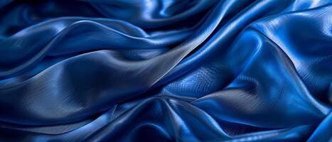 Rippling azure blue satin draped in fluid waves, the light playing across the lustrous folds of the vibrant fabric. photo