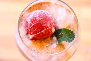 home made ice cream with raspberry, blackberry, mango fruits served in wine glasses. photo