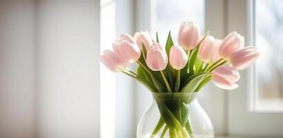 Fresh spring flowers banner red and yellow tulips bouquet in glass vase on table modern light interrior mothers day valentines photo