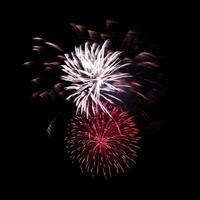 Colorful celebration fireworks isolated on black sky background. photo
