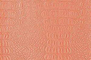 Orange coral crocodile leather texture. Abstract backdrop for design. photo