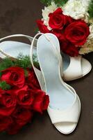 Red roses and bridal shoes photo