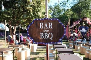 Vintage and retro sign for BBQ or barbecue wooden label in camping area photo