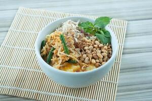 Bubur Ayam Krawu or Chicken porridge mix with various vegetables and bean photo