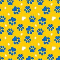 Blue paws of a cat or dog on a yellow background form a seamless pattern. vector