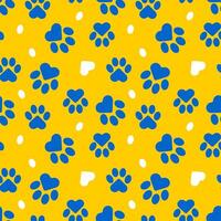 Blue paws of a cat or dog on a yellow background form a seamless pattern. vector