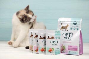 KHARKIV, UKRAINE - JANUARY 2, 2021 Optimeal cat meal packs. Optimeal is product by Kormotech LLC, a global family company, the largest producer of pet food in Ukraine photo