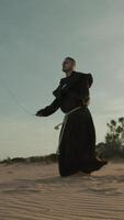 Religious Monk Does Jump Rope On The Soft Sand Beach video