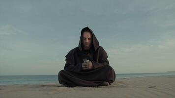 Monk Collected In Prayer Sitting On The Beach In The Evening video