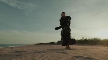 Monk Does Jump Rope Sport Cardio Training On The Soft Sand video