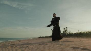 Religious Monk Does Jump Rope On The Soft Sand Beach video