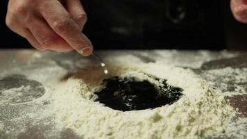 Chef Mixes The Dough With Flour Eggs And Cuttlefish Ink Food video