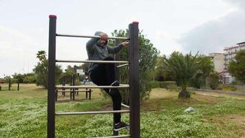 Man With Gray Hood Jumps And Does Somersault For Intensity Training video