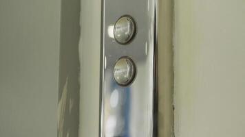 Man finger reaches in and presses elevator button which lights up. HDR. Close up of metal buttons of a public elevator. video