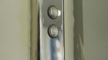 Elevator button and a beige wall. HDR. Close up of metal buttons of a public elevator aat the shopping center. video