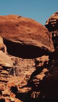 A large rock formation in the middle of a desert video