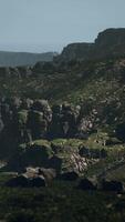 A view of a rocky mountain with green vegetation video