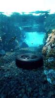 An underwater view of a tire in a rocky area video