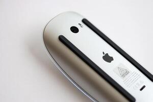 KYIV, UKRAINE - NOVEMBER 27, 2023 Apple Magic Mouse 3rd generation lies on white background photo