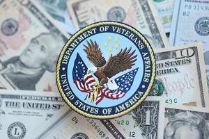 KYIV, UKRAINE - MARCH 9, 2024 US Department of Veteran Affairs seal on many US dollar bills photo