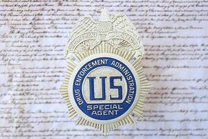 KYIV, UKRAINE - MARCH 9, 2024 US DEA Special Agent badge on United States Constitution photo