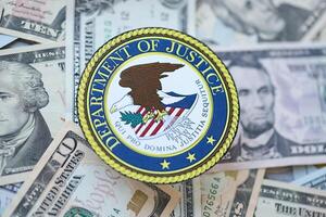 KYIV, UKRAINE - MARCH 9, 2024 US Department of Justice seal on many US dollar bills photo