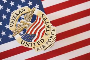 KYIV, UKRAINE - MARCH 9, 2024 US Air Force Veteran badge on United States of America flag photo