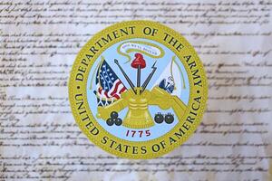 KYIV, UKRAINE - MARCH 9, 2024 US Department of Army seal on United States Constitution photo