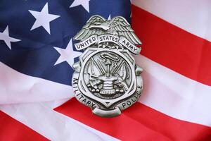 KYIV, UKRAINE - MARCH 9, 2024 US Army Military Police badge on United States of America flag photo