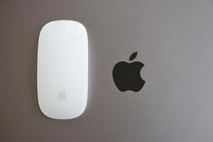 KYIV, UKRAINE - NOVEMBER 27, 2023 Apple Magic Mouse 3rd generation lies with grey MacBook 2021 photo