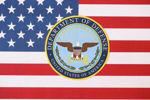 KYIV, UKRAINE - MARCH 9, 2024 US Department of Defense seal on United States of America flag photo