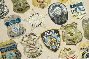 KYIV, UKRAINE - MARCH 9, 2024 Badges of different United States police departments printed on paper photo