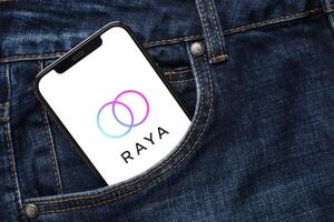 KYIV, UKRAINE - FEBRUARY 23, 2024 Raya logo of famous dating website or app on iPhone display photo