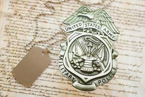 KYIV, UKRAINE - MARCH 9, 2024 US Army Military Police badge with dogtags on United States Constitution photo