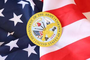 KYIV, UKRAINE - MARCH 9, 2024 US Department of Army seal on United States of America flag photo