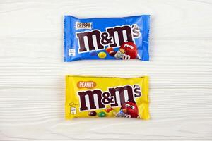 KHARKIV, UKRAINE - JANUARY 2, 2021 M and Ms colorful button shaped chocolate candies. Multi colored chocolates each of which has the letter m printed in lower case in white photo