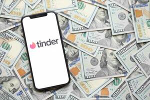 KYIV, UKRAINE - FEBRUARY 23, 2024 Tinder logo of famous dating website or app on iPhone display photo