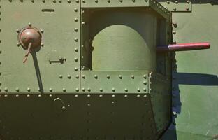 The texture of the wall of the tank, made of metal and reinforced with a multitude of bolts and rivets. Images of the covering of a combat vehicle from the Second World War with a guided machine gun photo