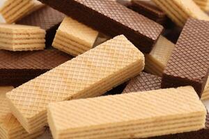 Stacked delicious chocolate wafers in large amount. Two different flavours of classic waffles photo