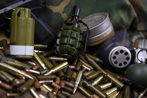 Different types of ammunition on a camouflage background. Preparing for war photo