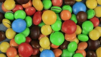 Candy sweets background. Assorted colorful chocolate candies. Colorful delicious sweets turning top view. video