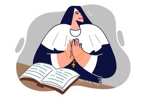 Praying catholic woman stands near open bible and folds palms in front of chest. vector