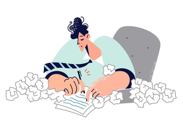 Business man is doing paperwork and writing speech, sitting at desk, with many crumpled drafts